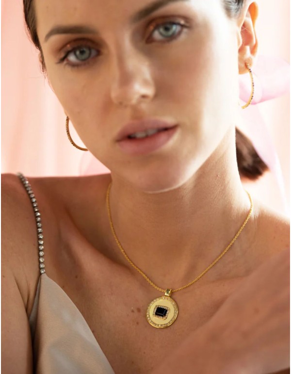 Pendant with a medallion featuring a blue center stone...