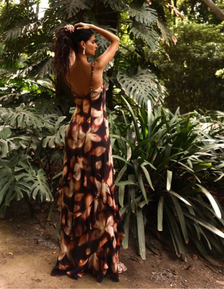 Long, earth-toned printed dress for a wedding guest with an asymmetrical skirt