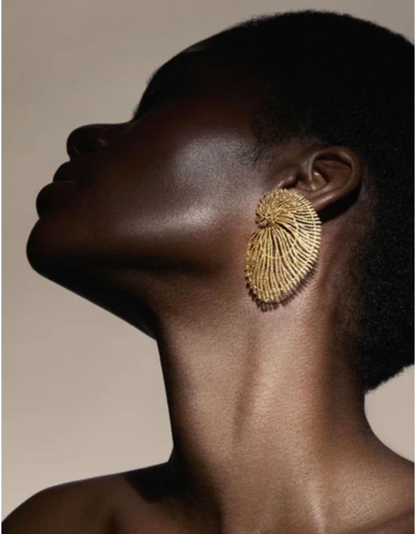 Large gold earrings shaped like seashells