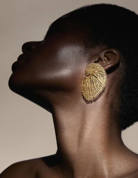 Large gold earrings shaped like seashells