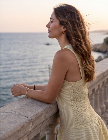 Yellow striped midi dress with ruffles and a honeycomb-patterned back