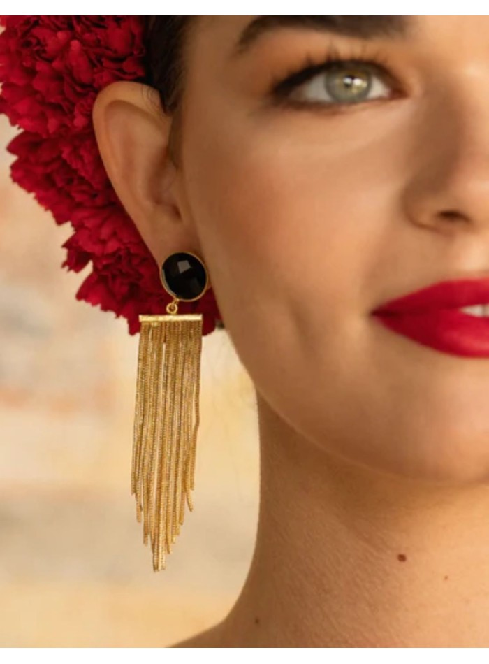 Long gold earrings with fringe and a black stone