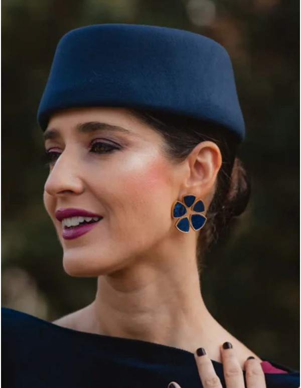 Gold earrings with blue stones in a circular design
