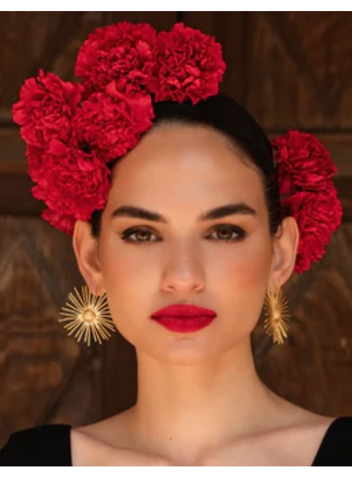 Circular gold earrings shaped like the sun