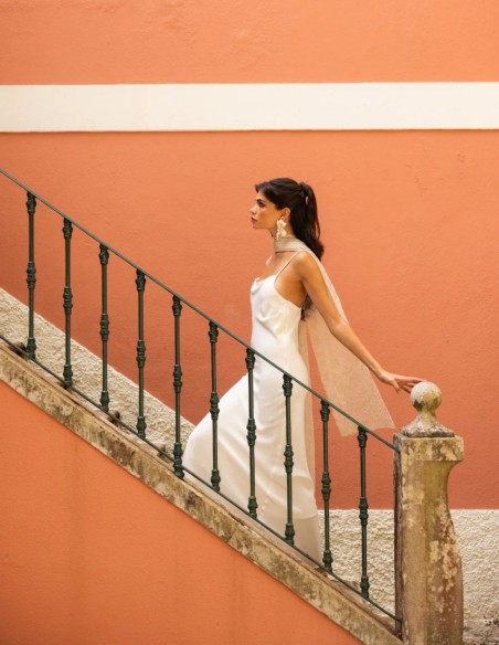 Long lingerie-style dress with thin straps and a semi-draped neckline
