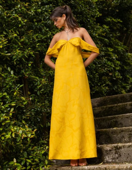 Long saffron-yellow dress with a subtle print and a Bardot neckline