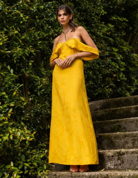 Long saffron-yellow dress with a subtle print and a Bardot neckline