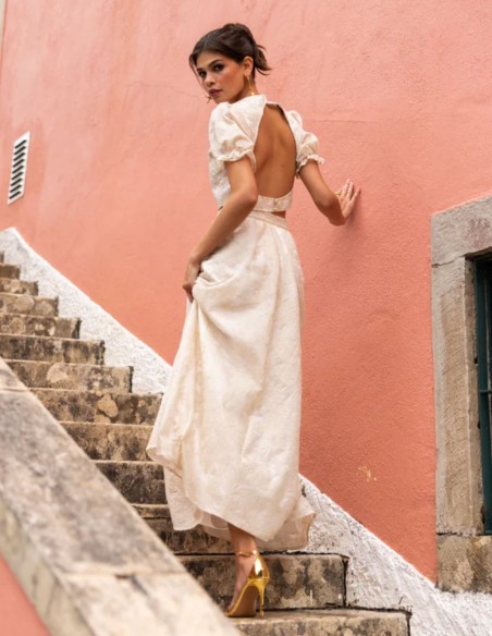 Ivory-colored embroidered midi skirt with a flared hem