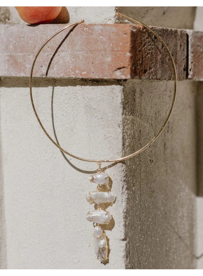 Handcrafted necklace with a central ring and...