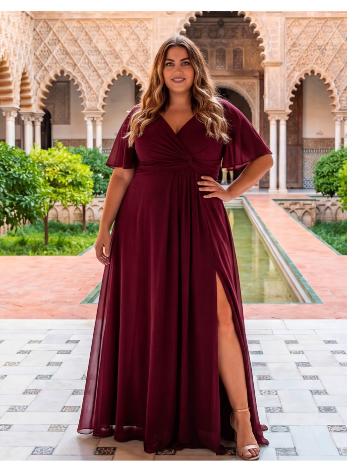 Long burgundy evening dress for plus sizes with a V-neckline, flowing sleeves, a draped waist