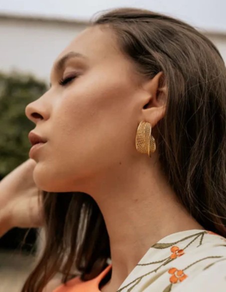 Large, curved gold hoops with a lattice design