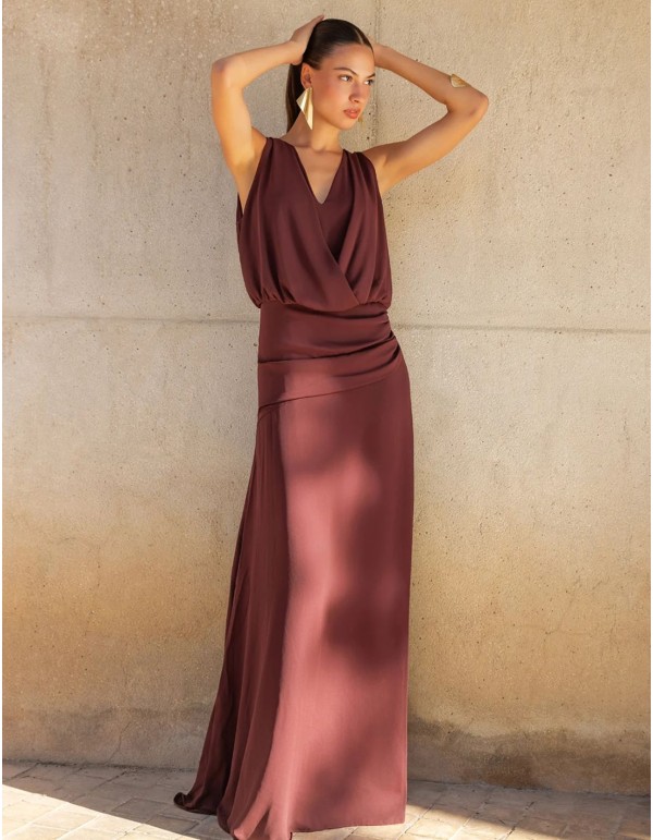 Long brown dress with a crossover neckline and a draped...