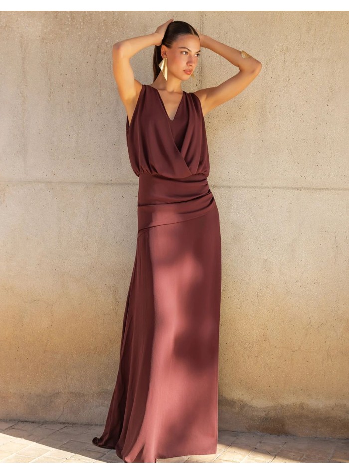 Long brown dress with a crossover neckline and...