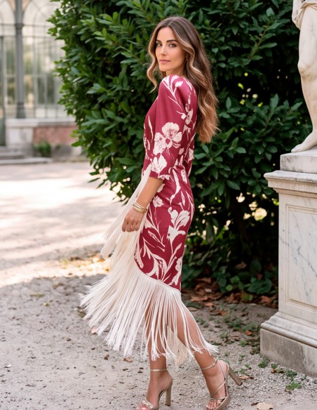 Midi dress with a maroon floral print, long fringe, and a crossover neckline.