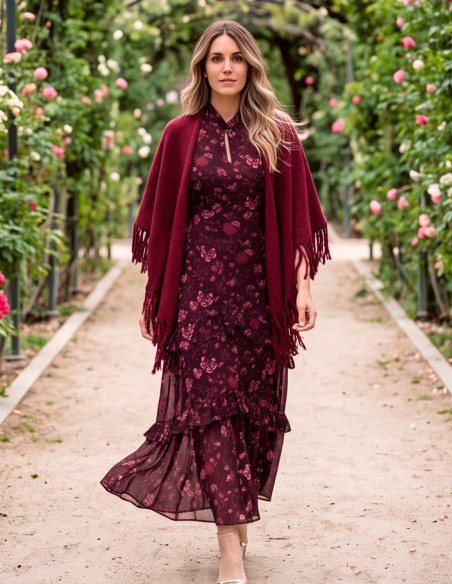 A maroon fringed poncho, crafted from a soft, enveloping fabric