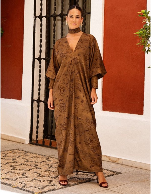 Brown kaftan with a floral print, featuring a V-neck and...
