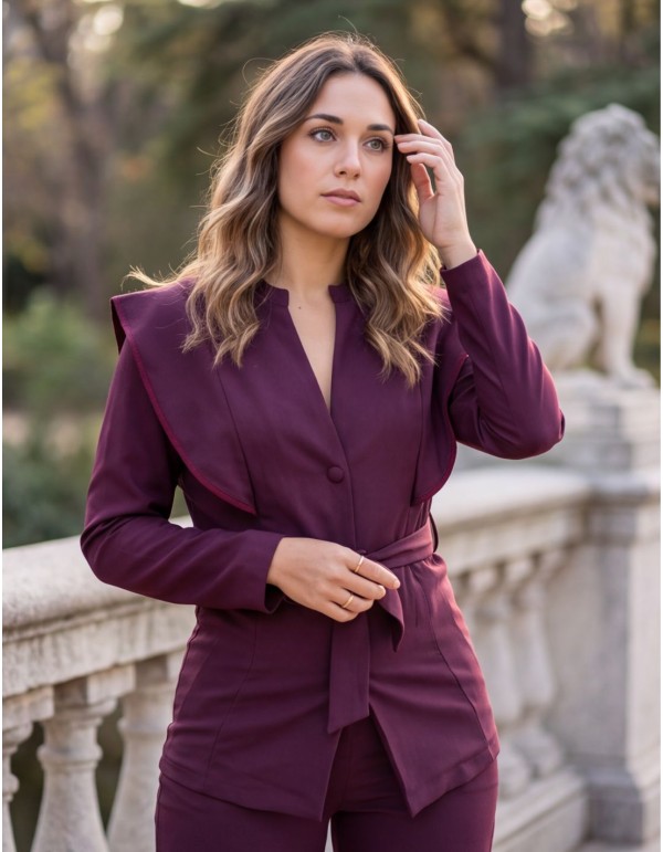 Burgundy two-piece suit with a structured jacket and...