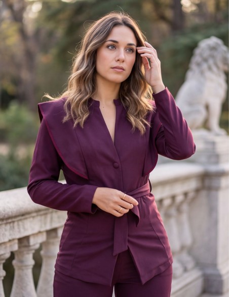 Burgundy two-piece suit with a structured jacket and straight-leg pants