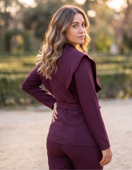 Burgundy two-piece suit with a structured jacket and straight-leg pants
