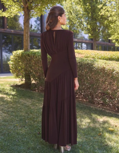 Long brown dress with an asymmetrical design and draping