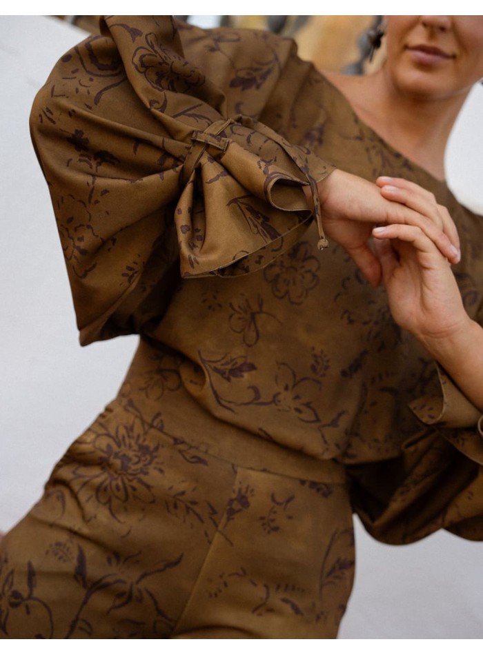 Green top with batwing sleeves and a brown print