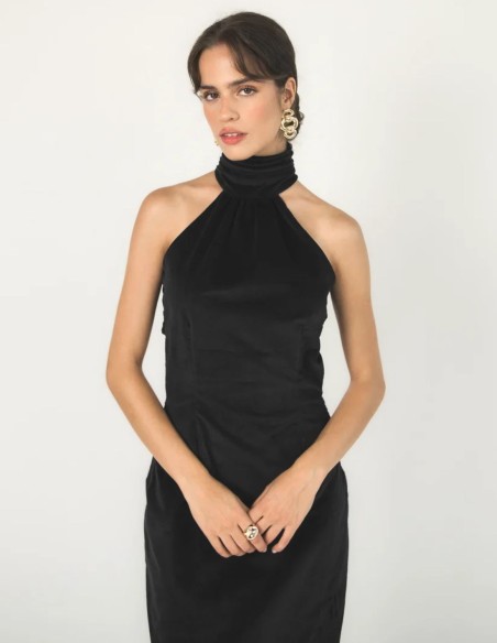 Long black velvet dress with a halter neckline and an open back