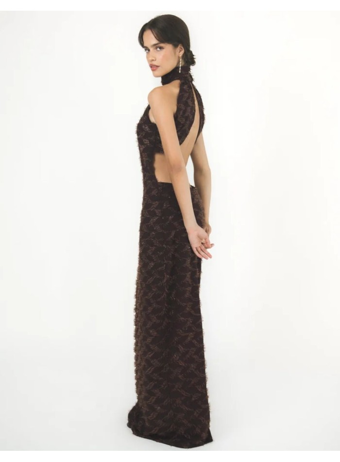 Long brown dress with a halter neckline and an...