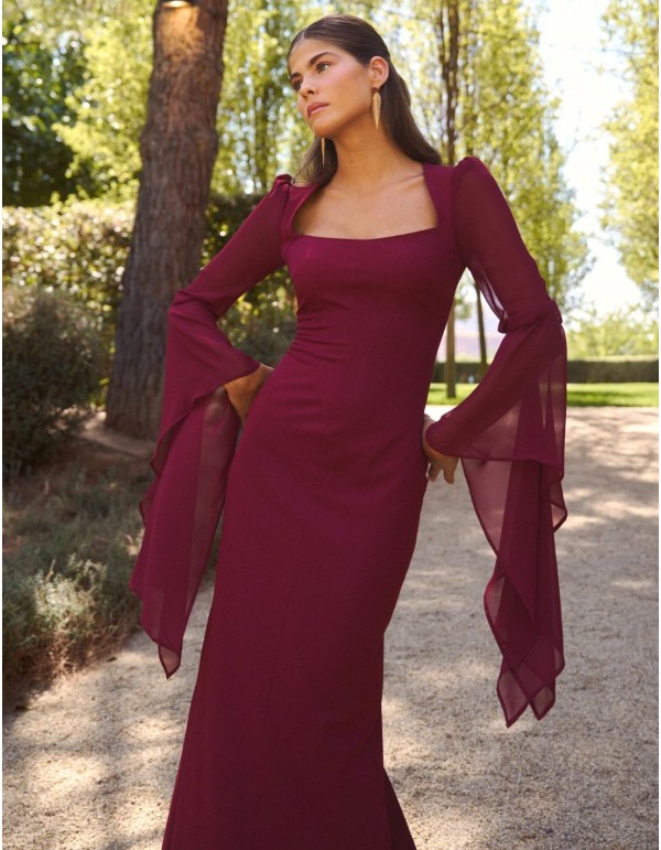 Long maroon dress with a straight neckline and flowing...