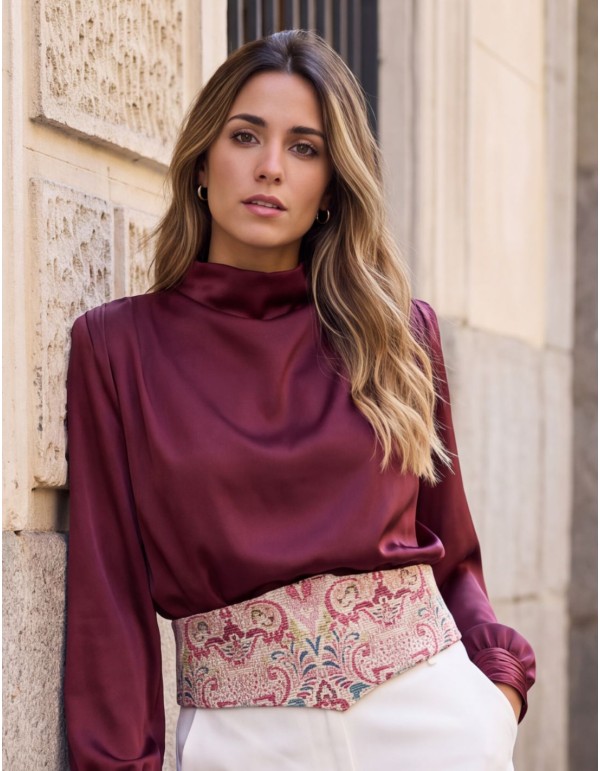 Close-up of the burgundy and blue print on the wide beige waist sash.