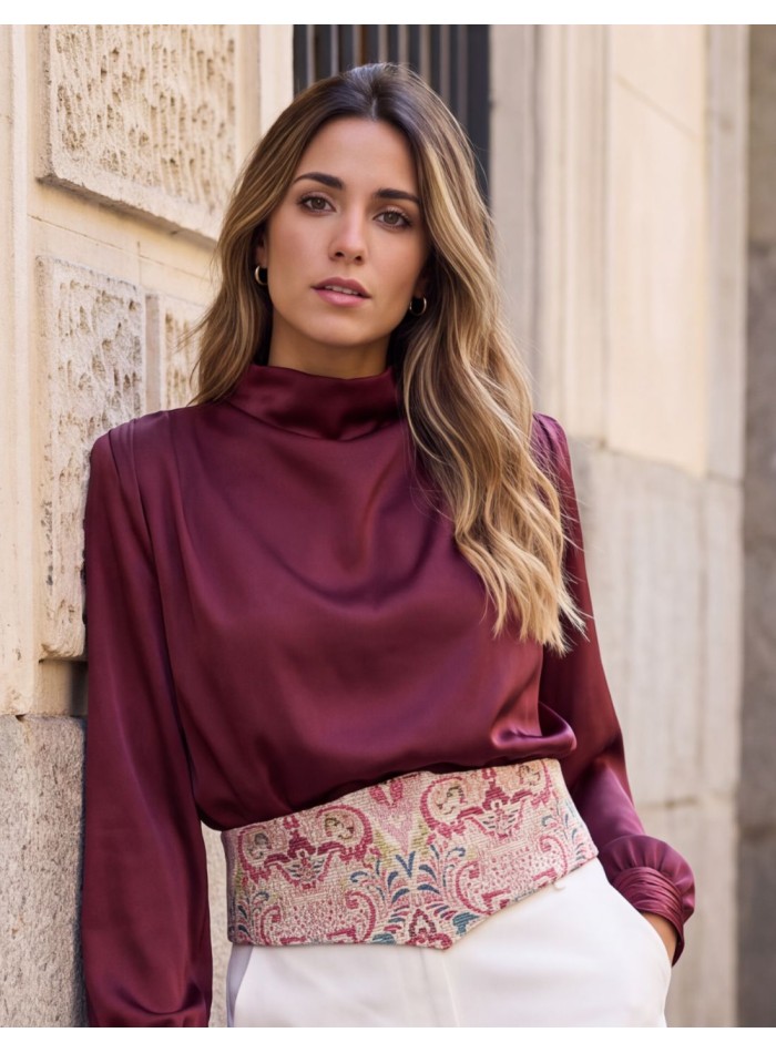 Close-up of the burgundy and blue print on the wide beige waist sash.
