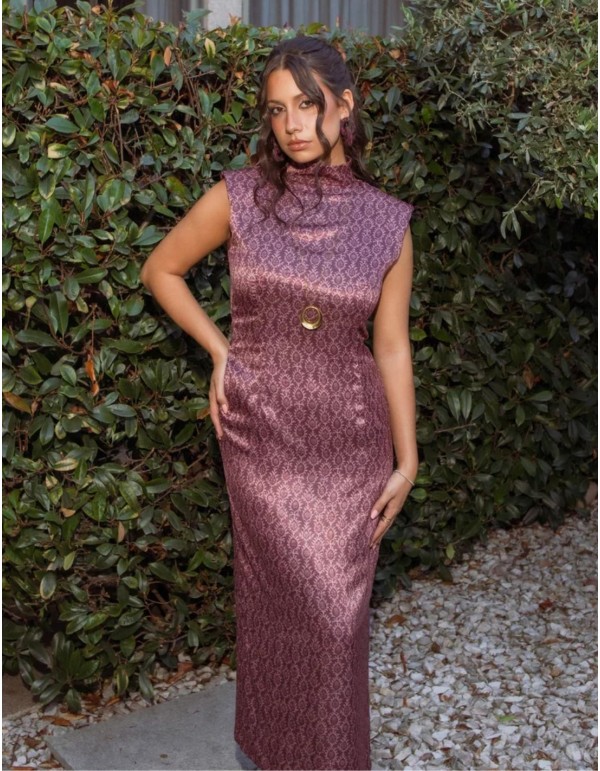 Detail of the structured high neckline and shoulders of the plum-coloured dress.