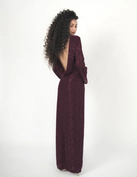 A long plum-colored dress made of velvet lace.