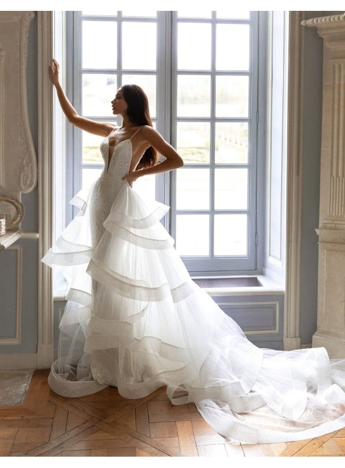 Wedding dress with a plunging V-neckline and detachable tail from Pollardi