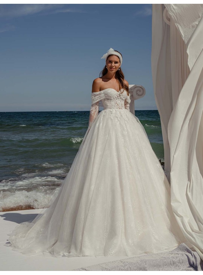 Princess cut wedding dress with wrap-around neckline and long sleeves in delicate lace by ANNIE VICTOR at INVITADISIMA