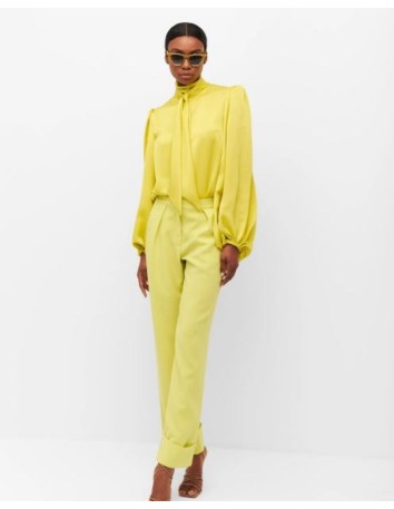 Lime-coloured trousers with a fluid cut from Cyrana Furs