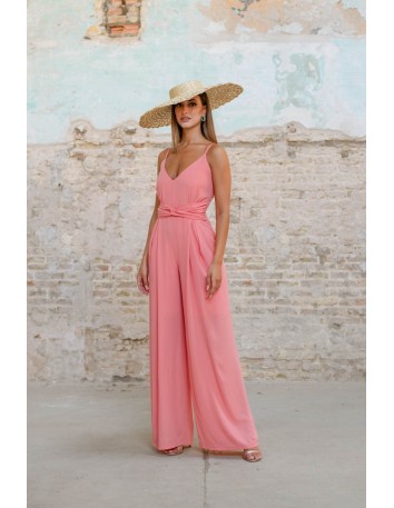 Pink jumpsuit with thin straps and knot detail at the waist
