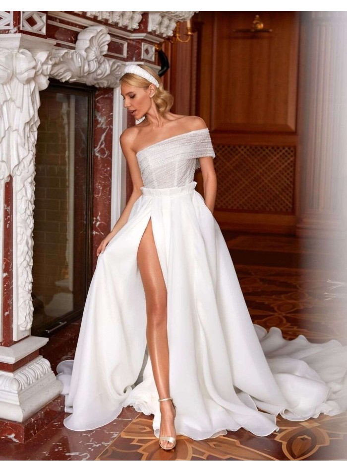 Wedding dress with asymmetrical neckline and side slit