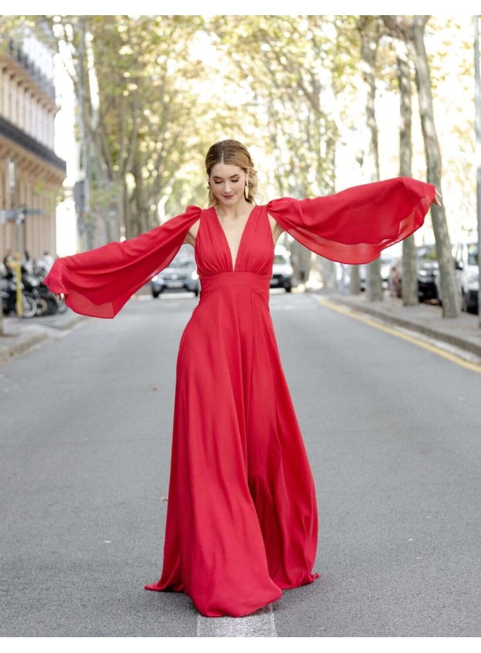 Long red flowing ball gown with cape sleeves