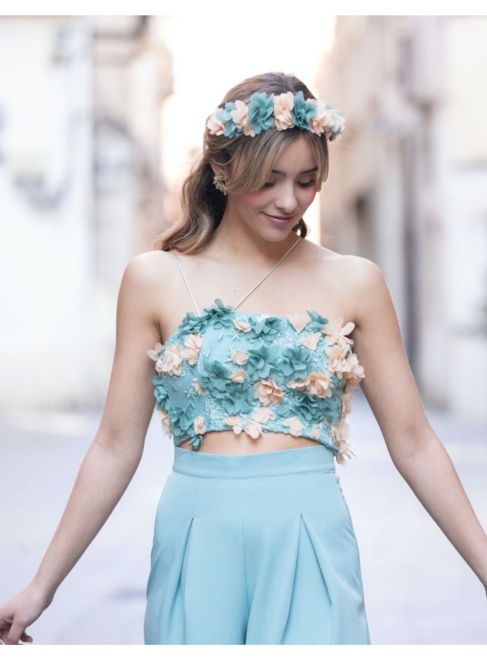 Party top with corseted closure covered with salmon and teal flowers.