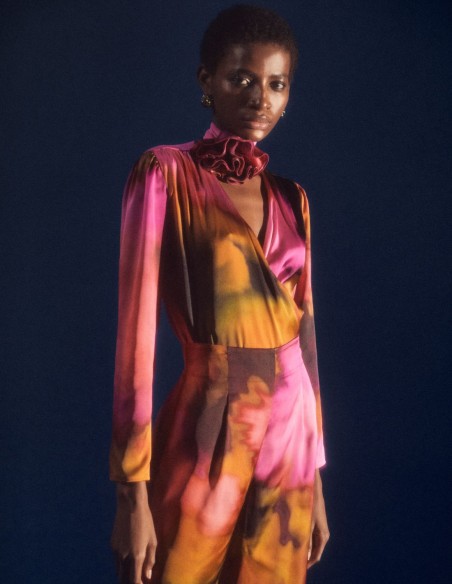 Satin party blouse with crossover neckline and floral embellishment