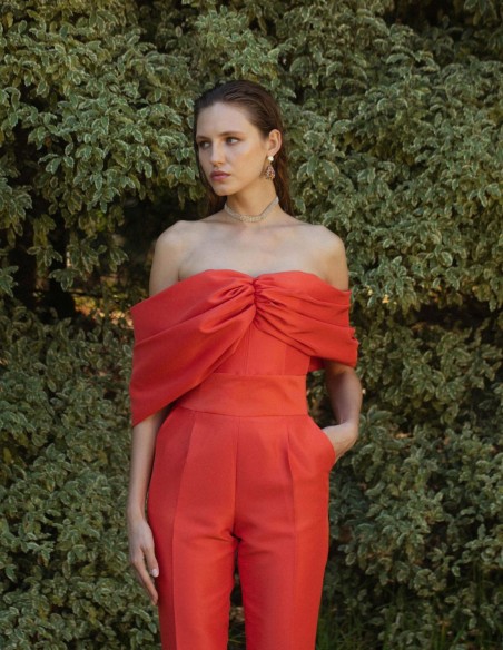 Draped crop top with strapless neckline in bright orange. Draped crop top with strapless neckline in bright orange.
