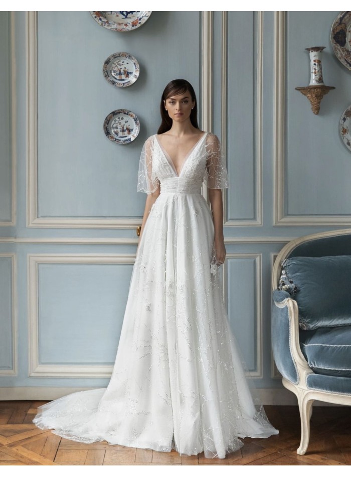 Wedding dress with sheer short sleeves and flowing skirt