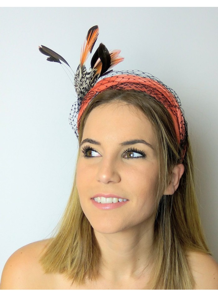 Orange headband with mesh overlay and feathers.