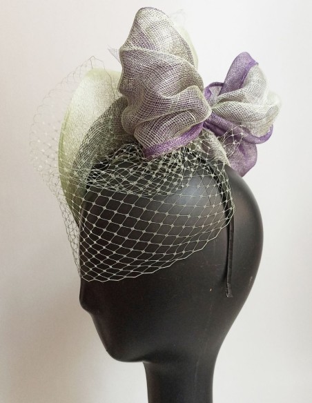 Veiled guest headpiece with raffia details. Veiled guest headpiece with raffia details.