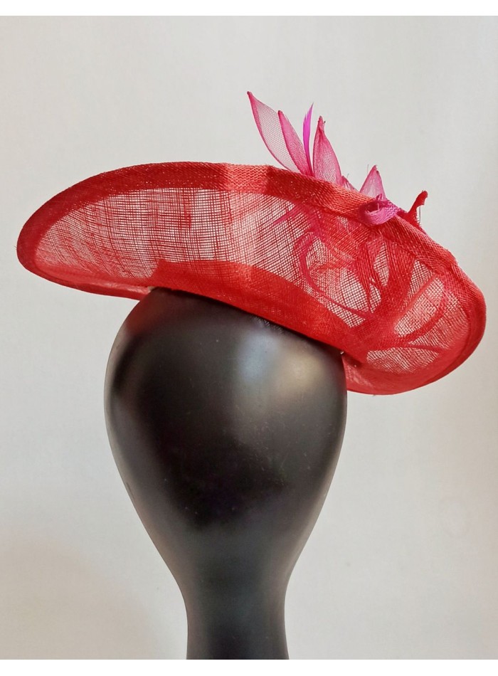 Dish style headpiece with feathers and flowers for guests.