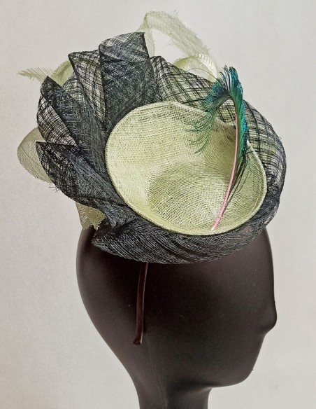 Tocado de rafia con pluma de pavo real.