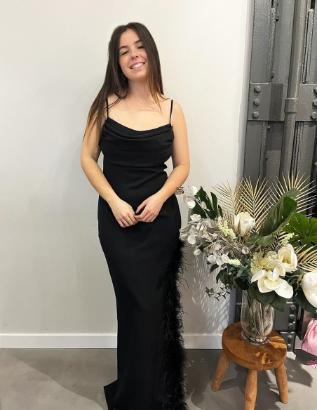 Long party dress with feathers in the opening. Long party dress with feathers in the opening.