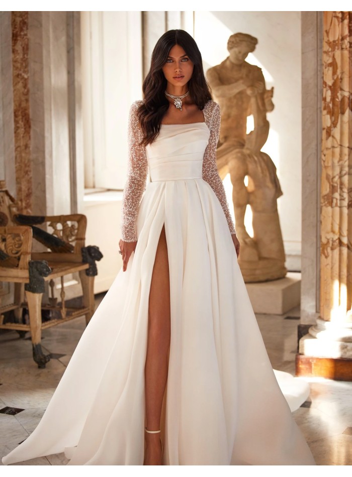 Long wedding dress with straight neckline and embroidered sleeves with rhinestones