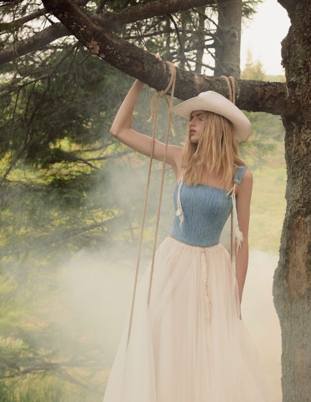 Blue denim corset with decorative feathers