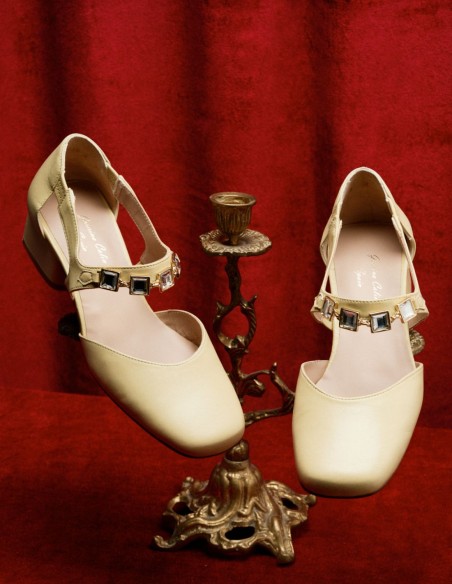 Cream pumps with stone buckle embellishment